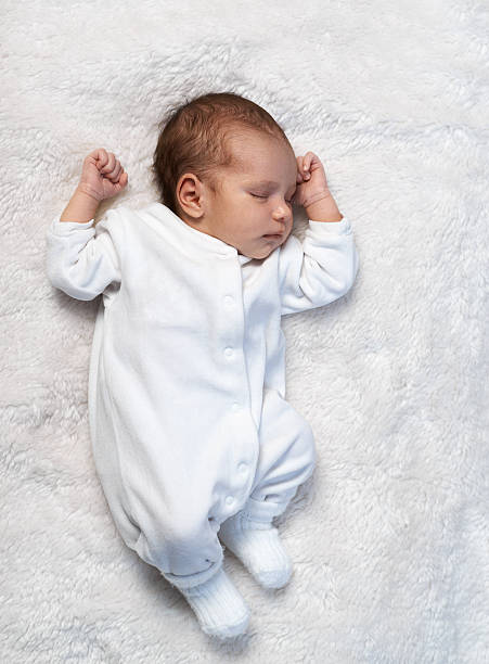 istock newborn baby sleeping on white fur in  sunlight 467906610