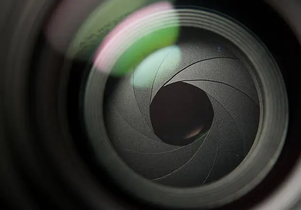 Photo of A close up of a camera lens partially open