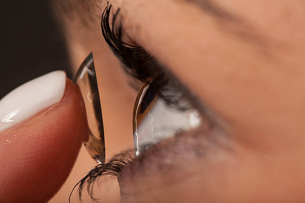 istock woman inserting contact lens 467908138