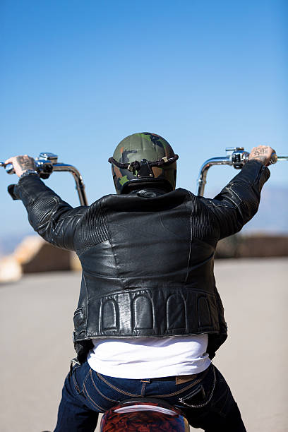 istock rear view of a chopper motorcyclist riding 467910416
