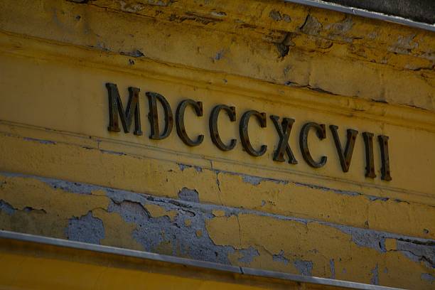 MDCCCXCVII roman numbers on a yellow wall