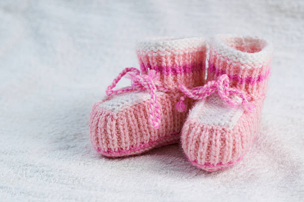 istock knitted pink baby boots 467915782