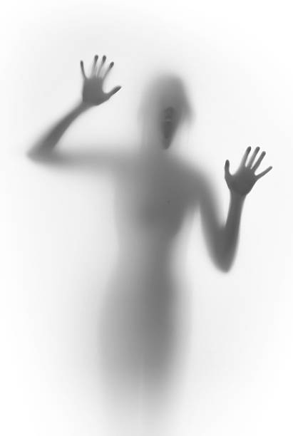 istock Shouting scary face and body silhouette behind a glass surface 467915812