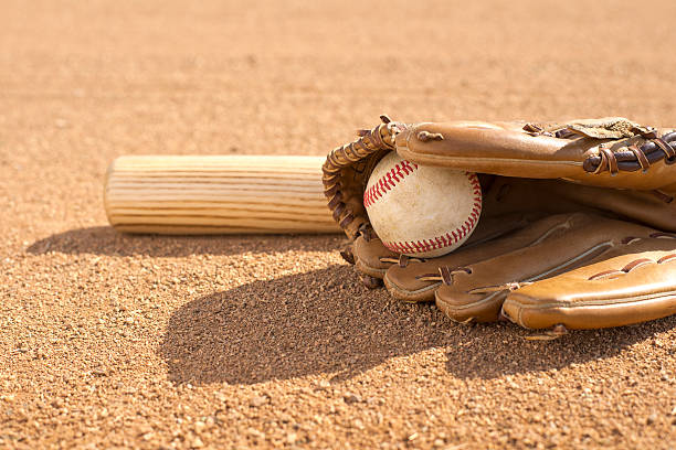 istock Baseball, bat, and glove on field 467915871