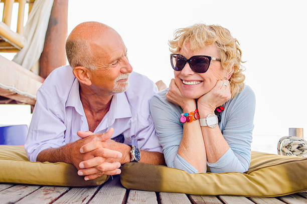 istock Happy Senior Couple on Vacation Lying on Front 467915964