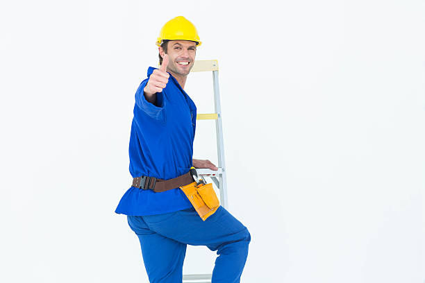 istock Repairman gesturing thumbs up while climbing step ladder 467916076