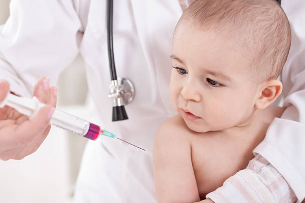 istock Doctor does injection child vaccination 467916890