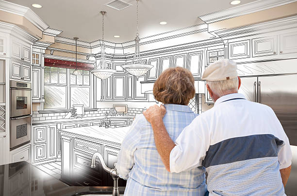 istock Senior Couple Looking Over Custom Kitchen Design Drawing and Pho 467917076