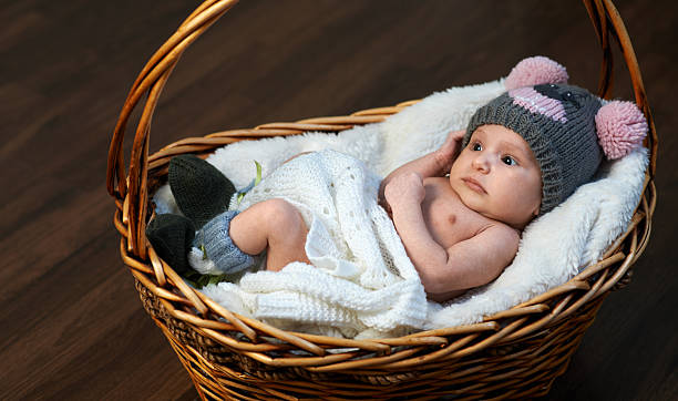 istock newborn baby in  cap  basket on  floor 467917182