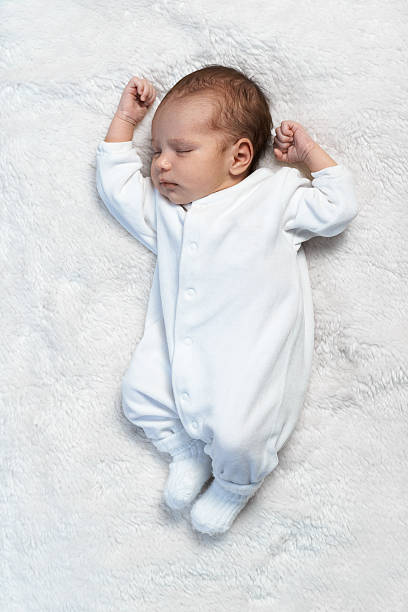 istock newborn baby sleeping on white fur in  sunlight 467917194