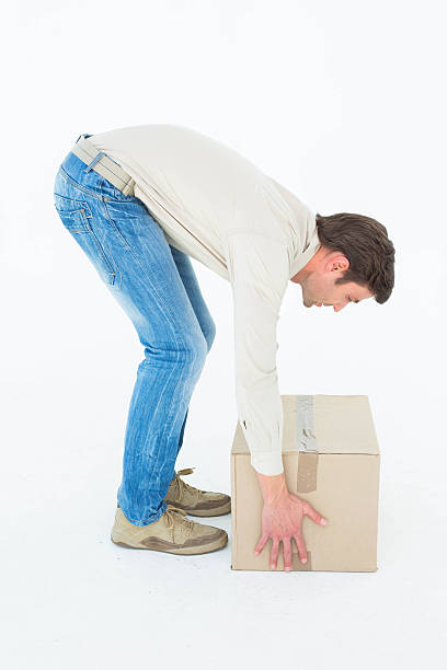 istock Side view of delivery man picking cardboard box 467917334