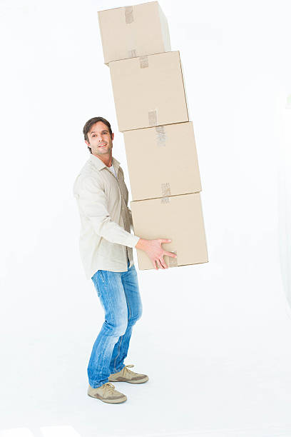 istock Portrait of courier man balancing cardboard boxes 467917368