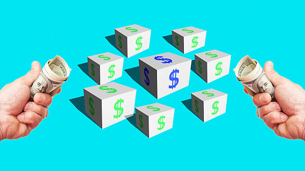 istock Cubes with a dollar sign and hands with currency 467917428