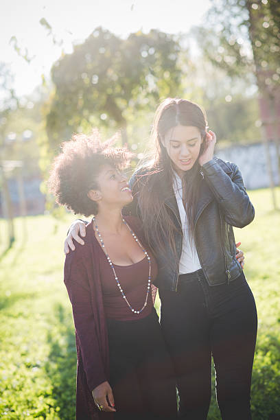 istock two multiethnic beautiful young woman black and white having fun 467918052