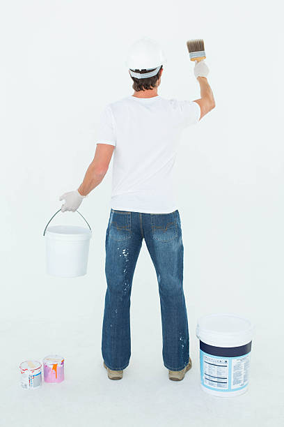 istock Rear view of man using paintbrush 467918456