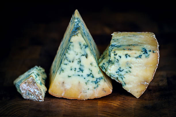 istock Stilton mature blue mouldy cheese - Dark background 467920121
