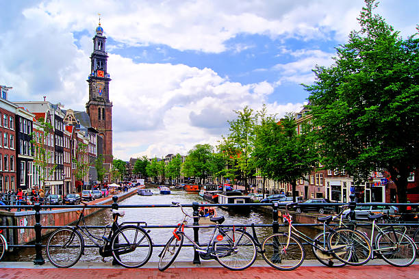 istock Amsterdam canal scene with church and bicycles 467920877