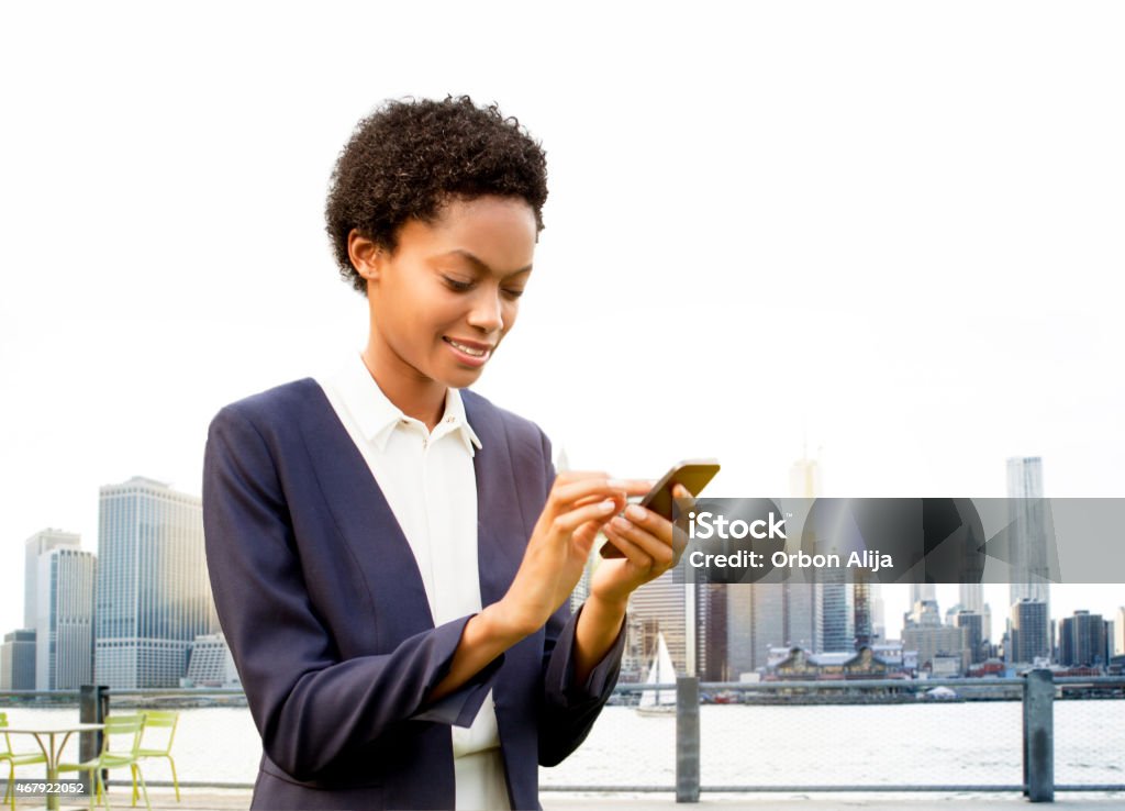 Businesswoman using smart phone in New York Businesswoman Stock Photo