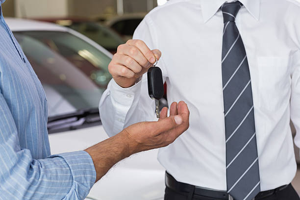 istock Businessman giving car key to customer 467922484