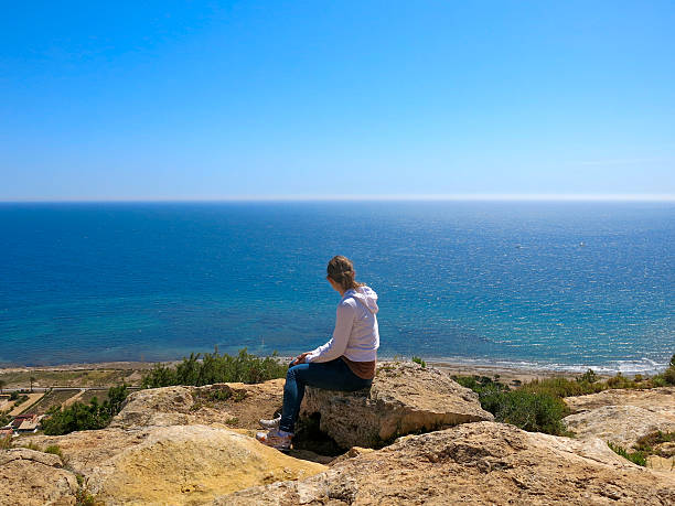 istock Girl looking out over the Mediterranean Sea 467922596