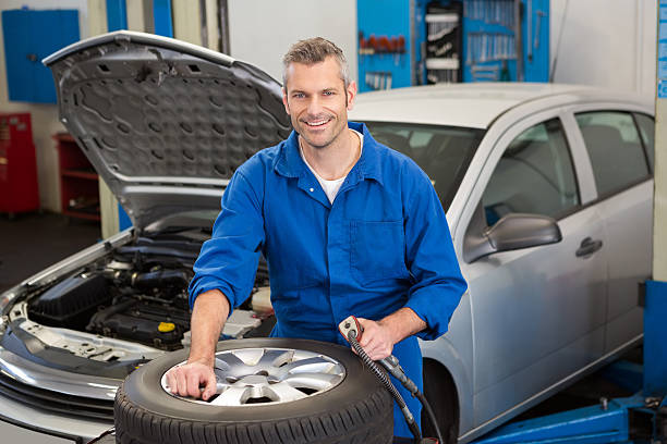 istock Smiling mechanic inflating the tire 467922816