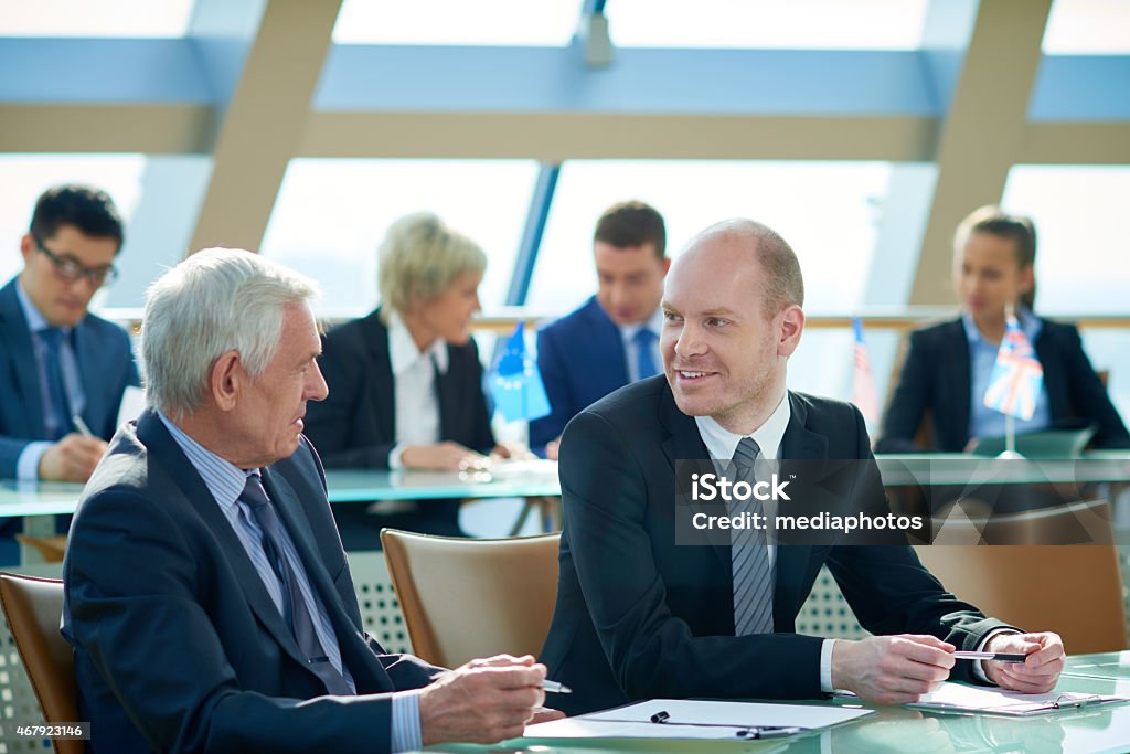 Business conference Two politicians discussing different topics at conference table Government Stock Photo