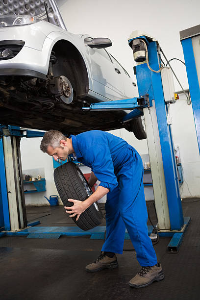 istock Mechanic adjusting the tire wheel 467923200