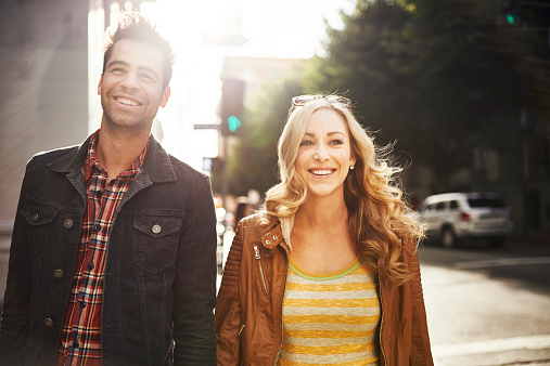 couple taking a walk through down town los angeles usa with lens flare