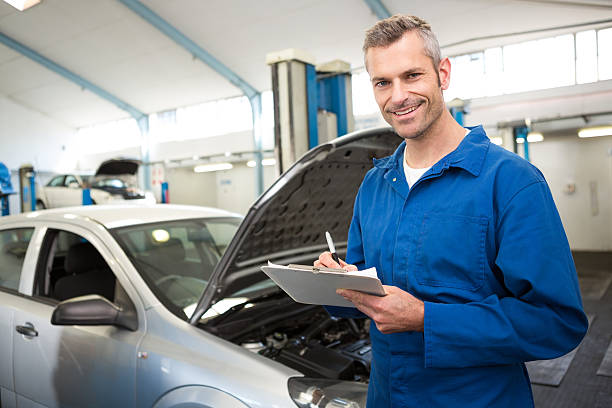 istock Hood open on a car as a mechanic takes notes 467923622