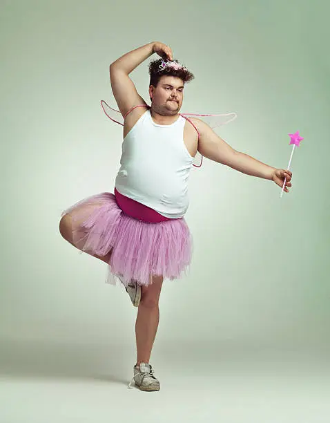 An overweight man comically dressed-up in a pink fairy costume doing ballethttp://195.154.178.81/DATA/istock_collage/0/shoots/783847.jpg