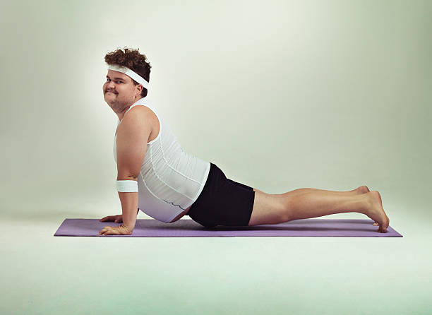 This upward facing dog pose is great Shot of an overweight man doing yoga poseshttp://195.154.178.81/DATA/istock_collage/0/shoots/783846.jpg eccentric photos stock pictures, royalty-free photos & images