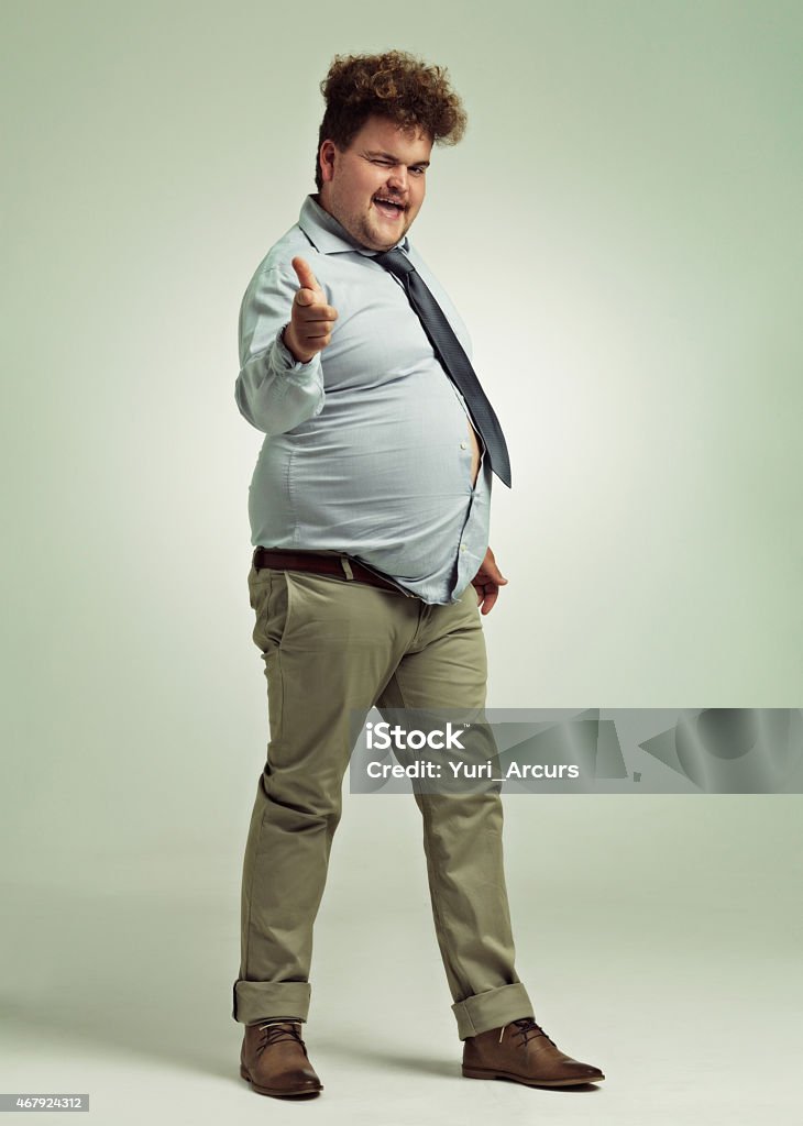 Nudge, nudge, wink, wink Full length shot of an overweight man pointing at the camerahttp://195.154.178.81/DATA/istock_collage/0/shoots/783845.jpg Men Stock Photo