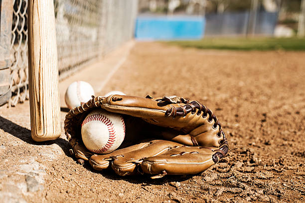 istock Baseball bat, glove and balls on field 467924441