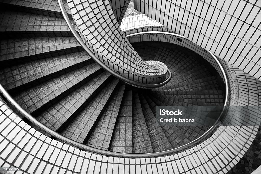 Spiral staircase High angle view of an old spiral staircase. Black And White Stock Photo