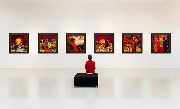 Exhibition centre, a visitor visits an art exhibition and watches artist's collection on the wall, 