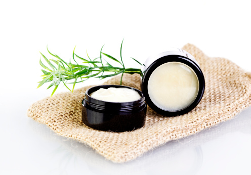 Natural lip balm and skin salve made with organic oils and butters in black tin