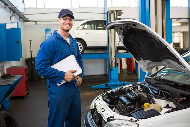 istock Smiling mechanic holding a clipboard 467924718