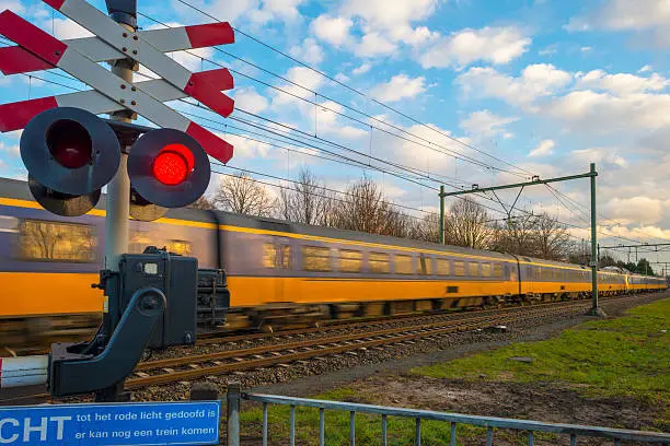Train passing a rail crossing in a city