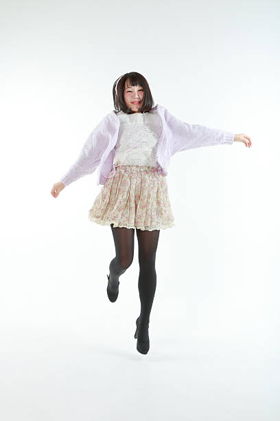 istock Female jumping while listening to music 467925658