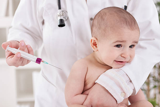 istock Sad baby receiving vaccine 467925834