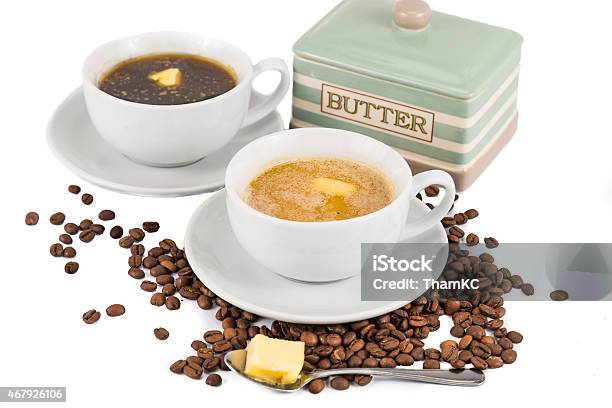Two Cups Of Coffee And Butter One Black And One With Milk Stock Photo - Download Image Now