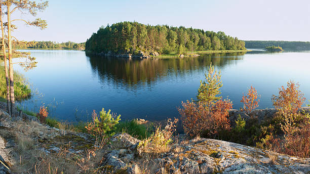 istock Ladoga lake with island under sunlight 467927380