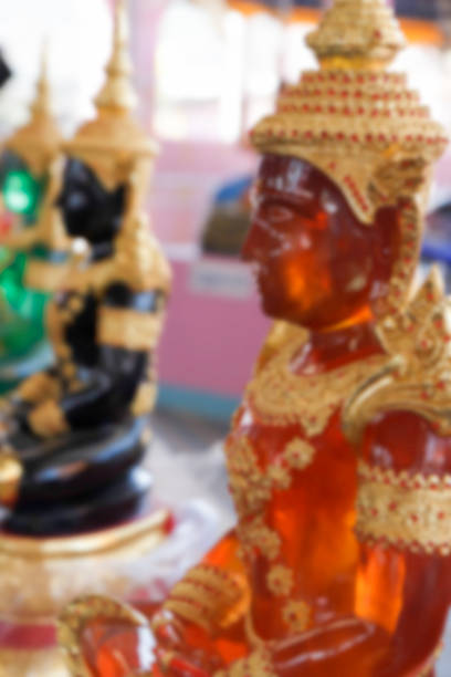 istock blurry defocused image of orange buddha statue for background 467927942