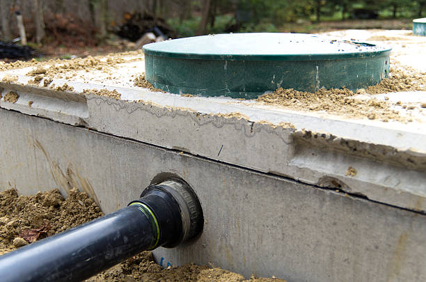 Septic Tank Installation View of sewage drainage pipe from house entering a cement septic tank. septic system stock pictures, royalty-free photos & images