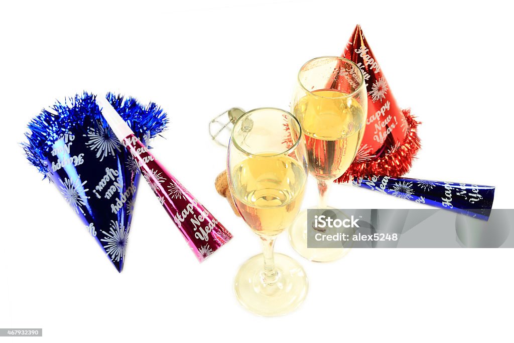 New Years Eve Party for two Glasses with (champagne) sparkling wine (one is with lipstick impression), cork, muselet, Party Hats and Horns remain after couple continues more intimate New Year Night Celebration 2015 Stock Photo