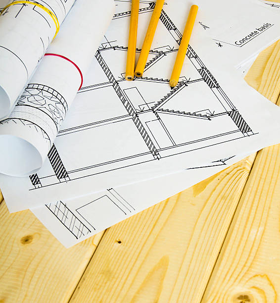 istock Many drawings for building and pencils on a wooden background 467934708