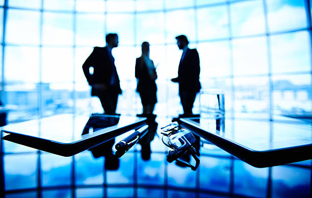 istock Three businessmen meeting in the dark 467935204