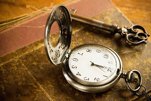 istock pocket watch key and old book 467939364