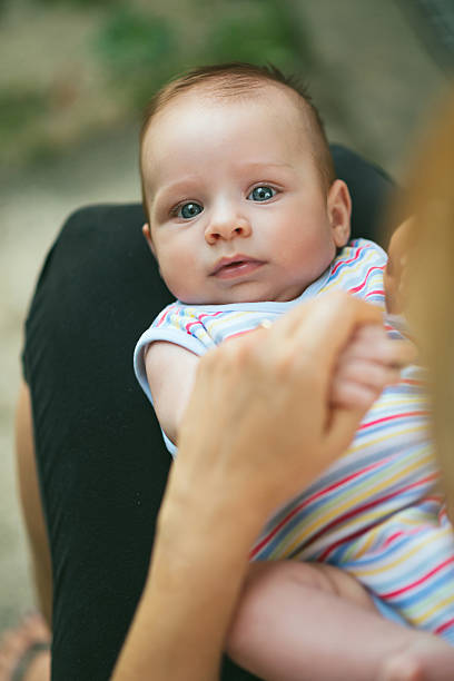 istock Loving mother holding baby boy in her lap 467940138