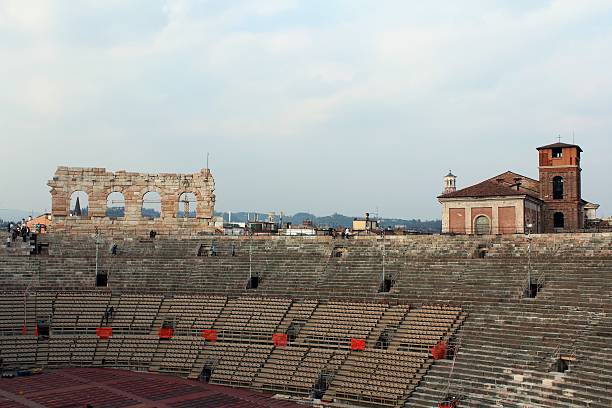 Arena Verona Italy Amphitheater Verona, Italy - March 23, 2015: Verona Arena Veneto Italy. Cloudy day, early afternoon. Inside the Verona Arena. Preparation for opera show in the Arena of Verona. Panoramic view over the rooftops of the city. Some tourists visit amphitheater. verona opera stock pictures, royalty-free photos & images